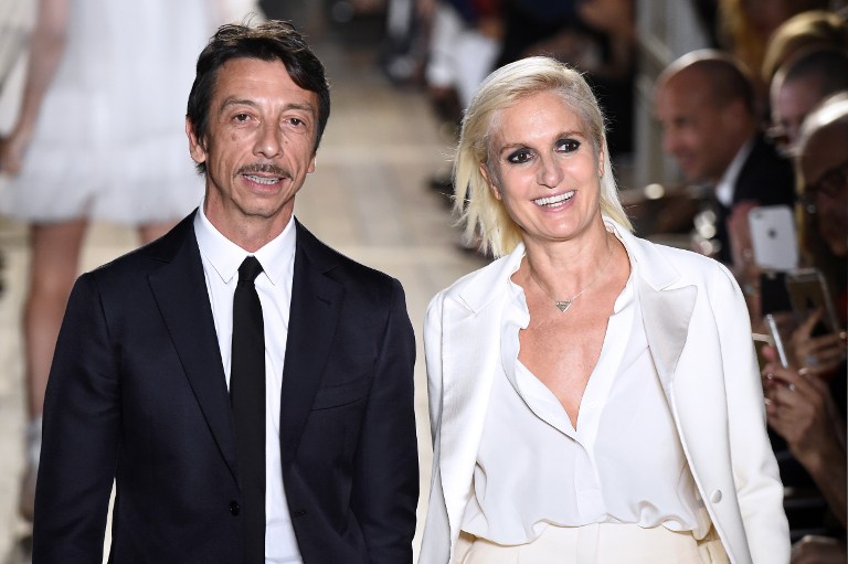 Valentino's Designers Maria Grazia Chiuri and Pierpaolo Piccioli at the end of the 2016-2017 autumn/winter Haute Couture fashion show on July 6, 2016 in Paris  (Photo by Bertrand Guay / AFP)